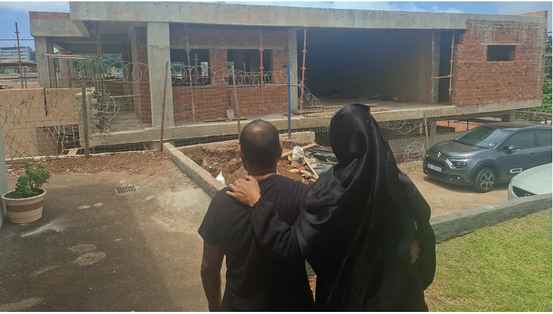 Rizana Karrim and her husband, Ridwaan, look at the three storey building where an application has been made for it to be used as a mosque.