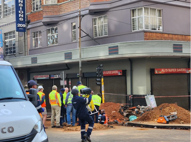 Technicians inspect the safest entry to the tunnel under the collapsed Lilian Ngoyi Road.