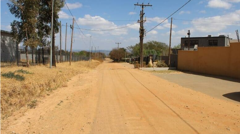  Residents are constantly exposed to dust clouds from traffic during peak hours on gravel Eastbourne Road. 