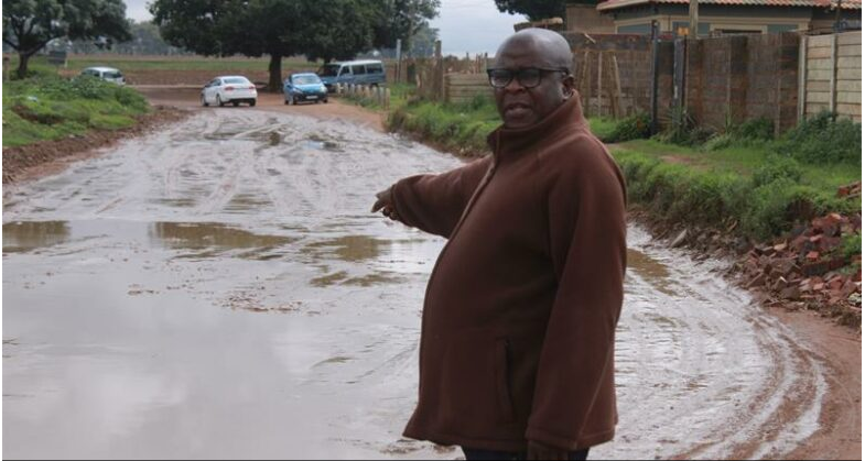  The Crocodile River Community Development Forum chairperson Patrick Tshikwiya points to a pool of water on the Crocodile River Road. 