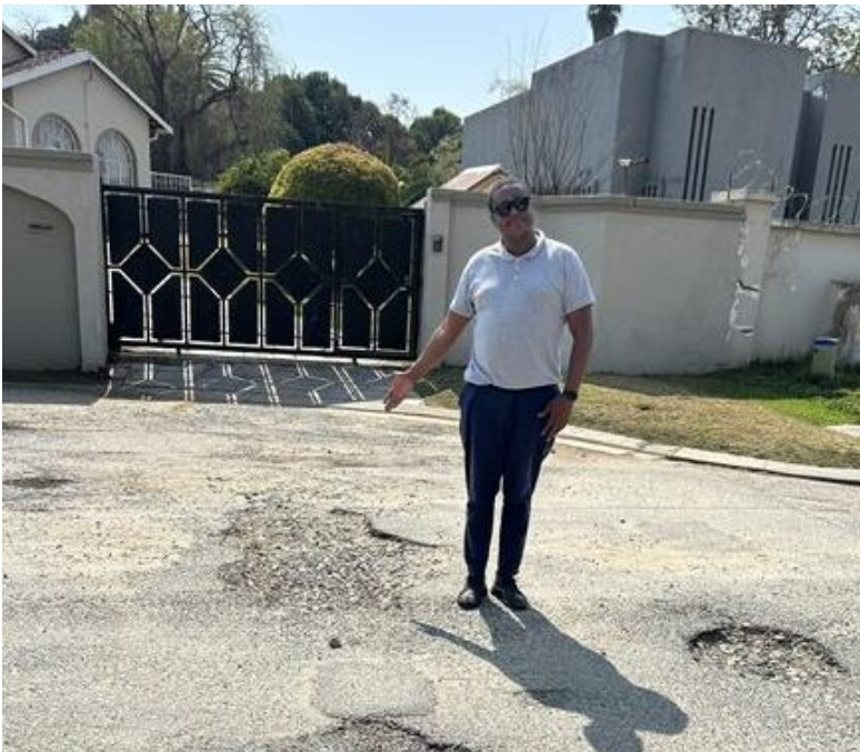  Community leader Theo Lengwati shows the poor state of Crystal Road in Bramley. 