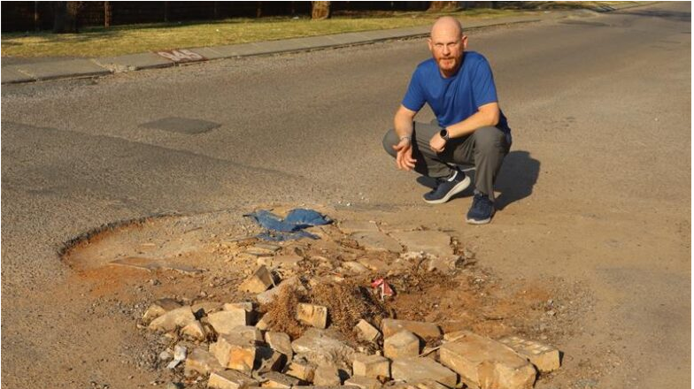  Tiaan Scholtz next to the Florin Road pothole.