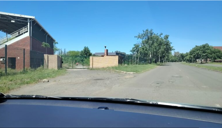  The entrance to what should be a functional Monte Vista Sports facility is overgrown with grass and untrimmed trees. 