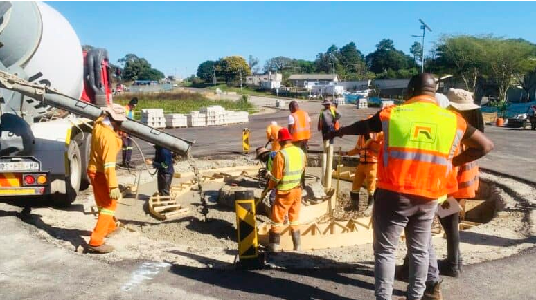 Workers construct a traffic circle.