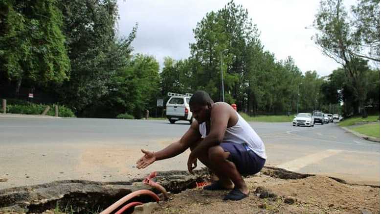  Siyabonga Lubisi points at the underlying tarred road which is badly compromised. 