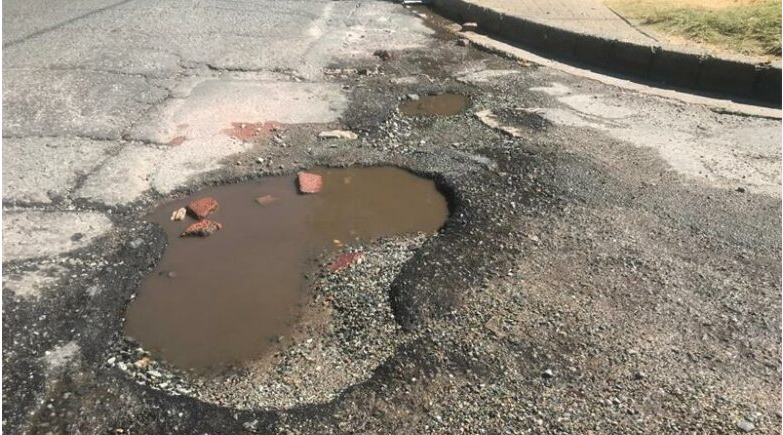  A pothole at the intersection of Oxford Street and Vine Avenue. 
