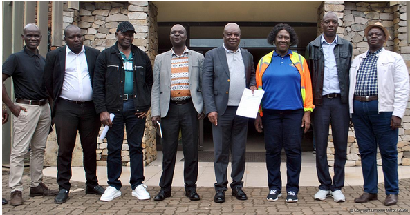 The mayor of Collins Chabane, Shadrack Maluleke (middle), is holding one of the appointment letters issued to the contractors. 