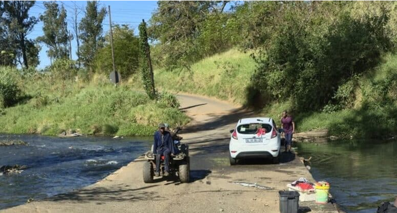 Local residents are pictured washing their vehicles at the low-lying Woodhouse Road bridge in Pietermaritzburg. Following repeated pleas from residents, Msunduzi Municipality has announced plans to upgrade the flood-prone bridge. 