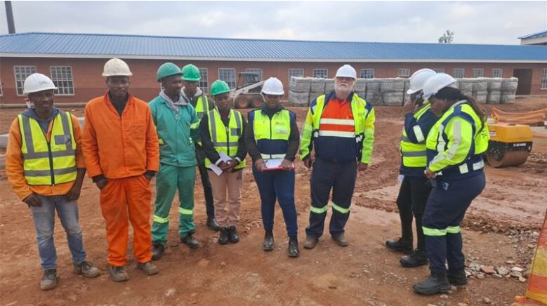  Project managers and construction workers on-site conducting a progress inspection. 