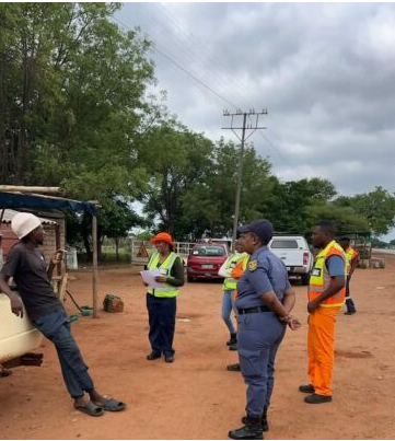 Members of the CPF and police briefing street vendors on compliance requirements under the National Roads Act.