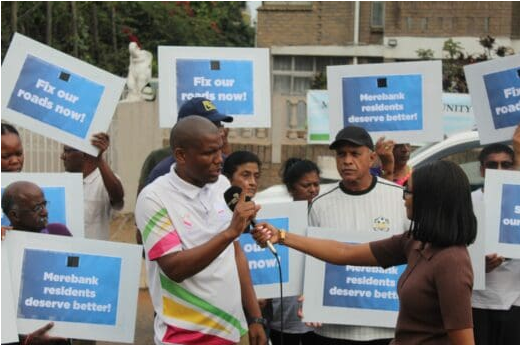PR councillor for the DA, Sithembiso Ngema, talking to a journalist during a picket demonstration in Merebank. 