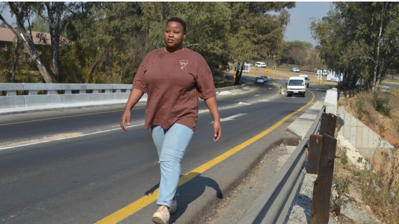 Sharon Mdaka walks over the portion of Modderfontein Road Bridge.
