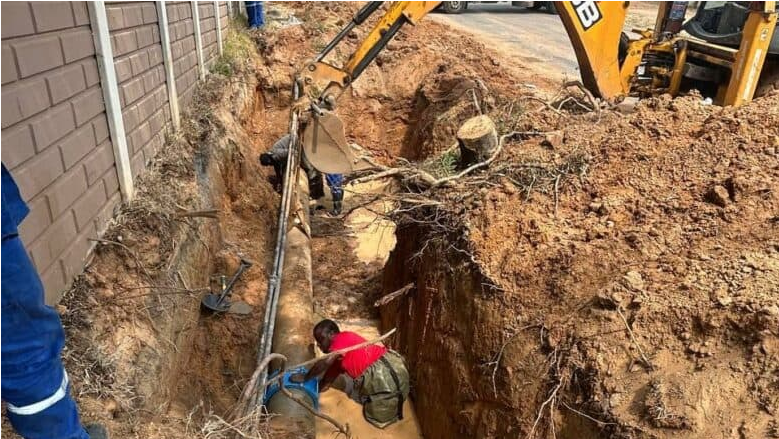  JW employees repair the leak on Pritchard Street. 