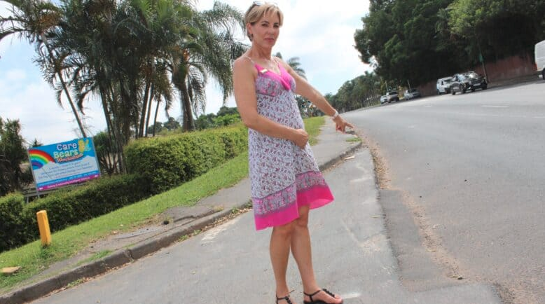  Carebears Wonderland principal Nila Ryan shows the road surface which is uneven due to incomplete tarring. 