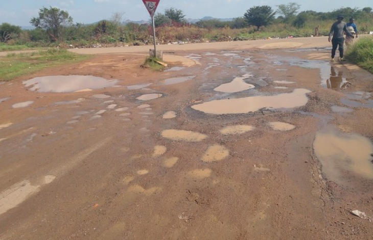 A pothole ridden road