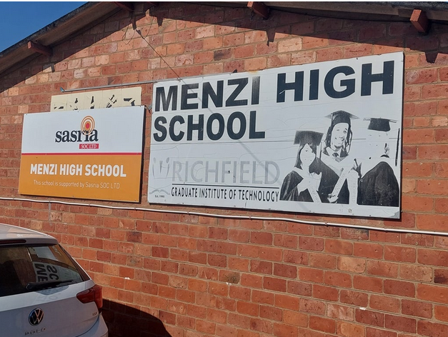  The extension of Menzi High School will be delayed by a year following at least six attempts to stop construction by armed gangs demanding to be paid 30% of the project