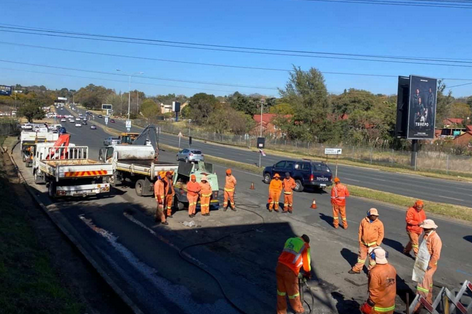 Technicians at work at the William Nicol Drive intersection on 12 July 2023.