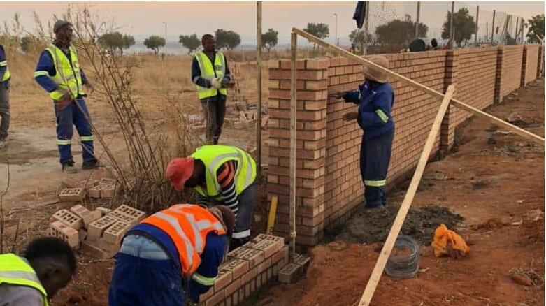  JDA contractors build a wall at the Midrand depot in Rabie Ridge.