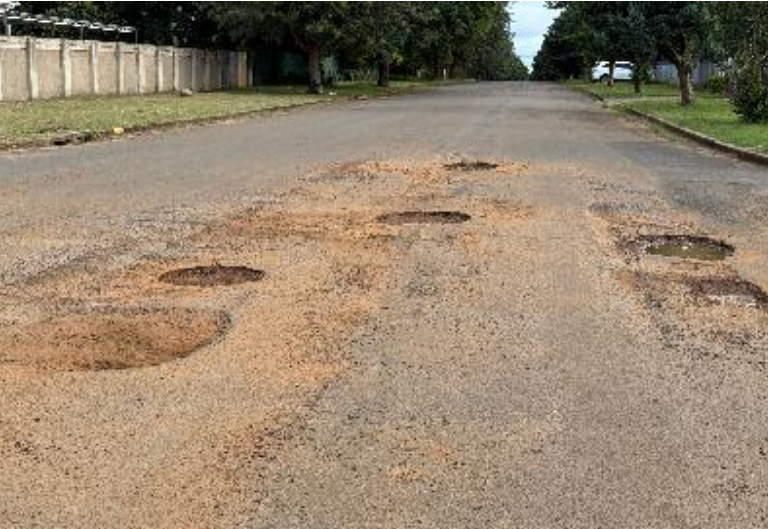  Road-users have to navigate deepening potholes. 