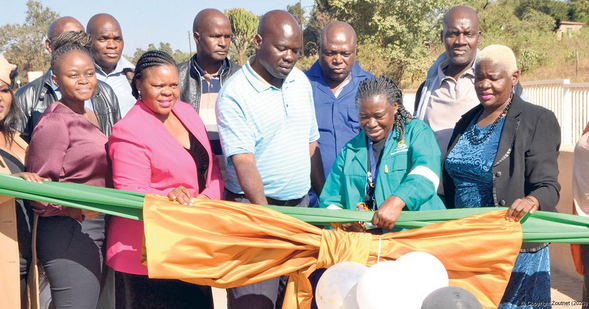 Thulamela Mayor Athingozwidivha Sarah Rammbuda (in the middle) cuts the ribbon to open the Lambani Bridge officially. 