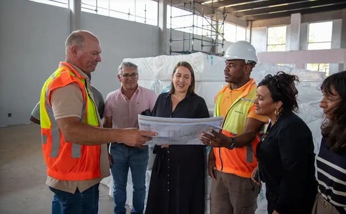 Francine Higham, wearing a black dress in the centre, with other officials during a recent site visit to the Lwandle library.