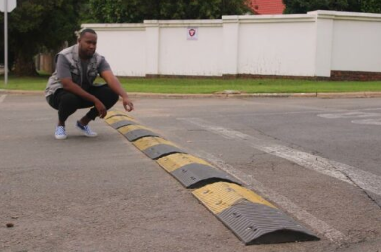 Kempton Express/Thembisan journalist Floyd Mathebula points at the plastic speedhump on Adrea Street, Glen Marais. 