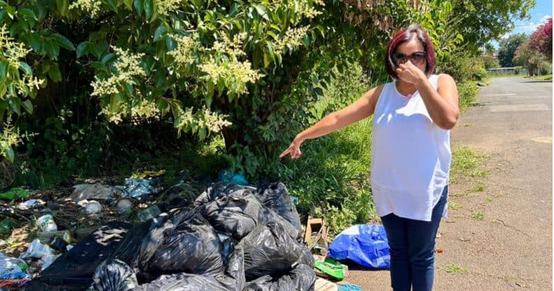 Ward councillor Suraya Reddy covers her nose as the odour from a pile of uncollected waste on Newton Road proved particularly pungent due to the extreme heat on Tuesday afternoon. 