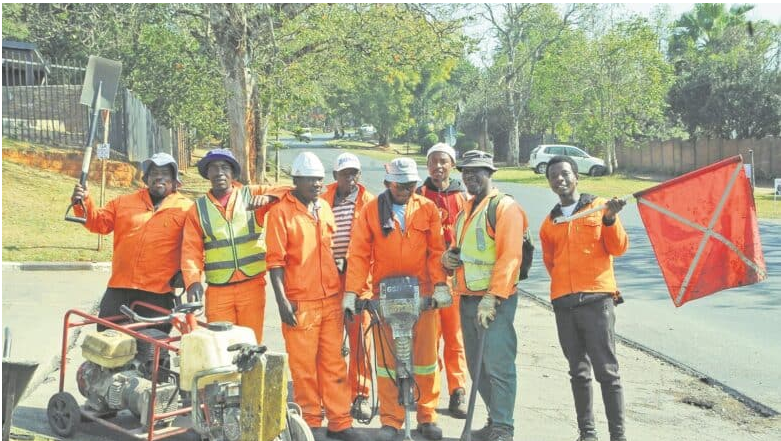 IHUBO Construction workers at the resurfaced Roberts Road in Clarendon.