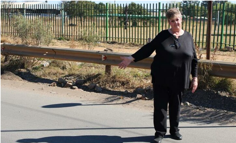 Bean Tree Café manager, Debbie Smith standing next to a fixed Sixth Road in Bredell AH on July 17. 